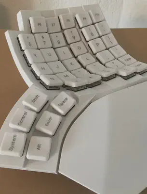 a picture of the right half of the keyboard, showing a pointy corner protruding next to the closest thumbkey